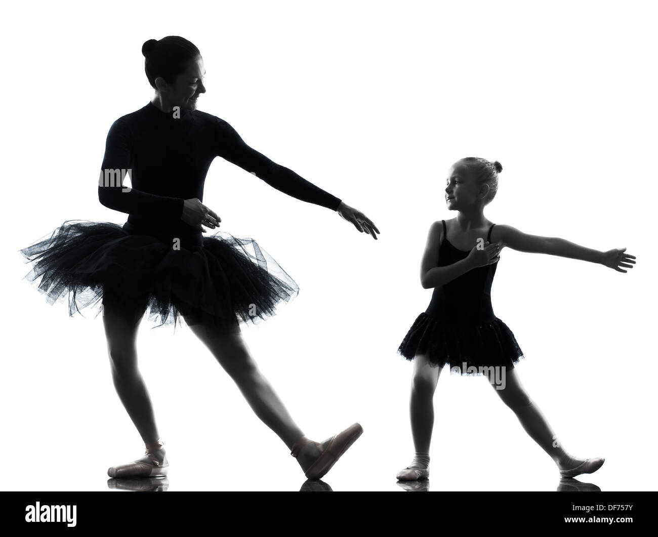 woman and little girl ballerina ballet dancer dancing in silhouette on