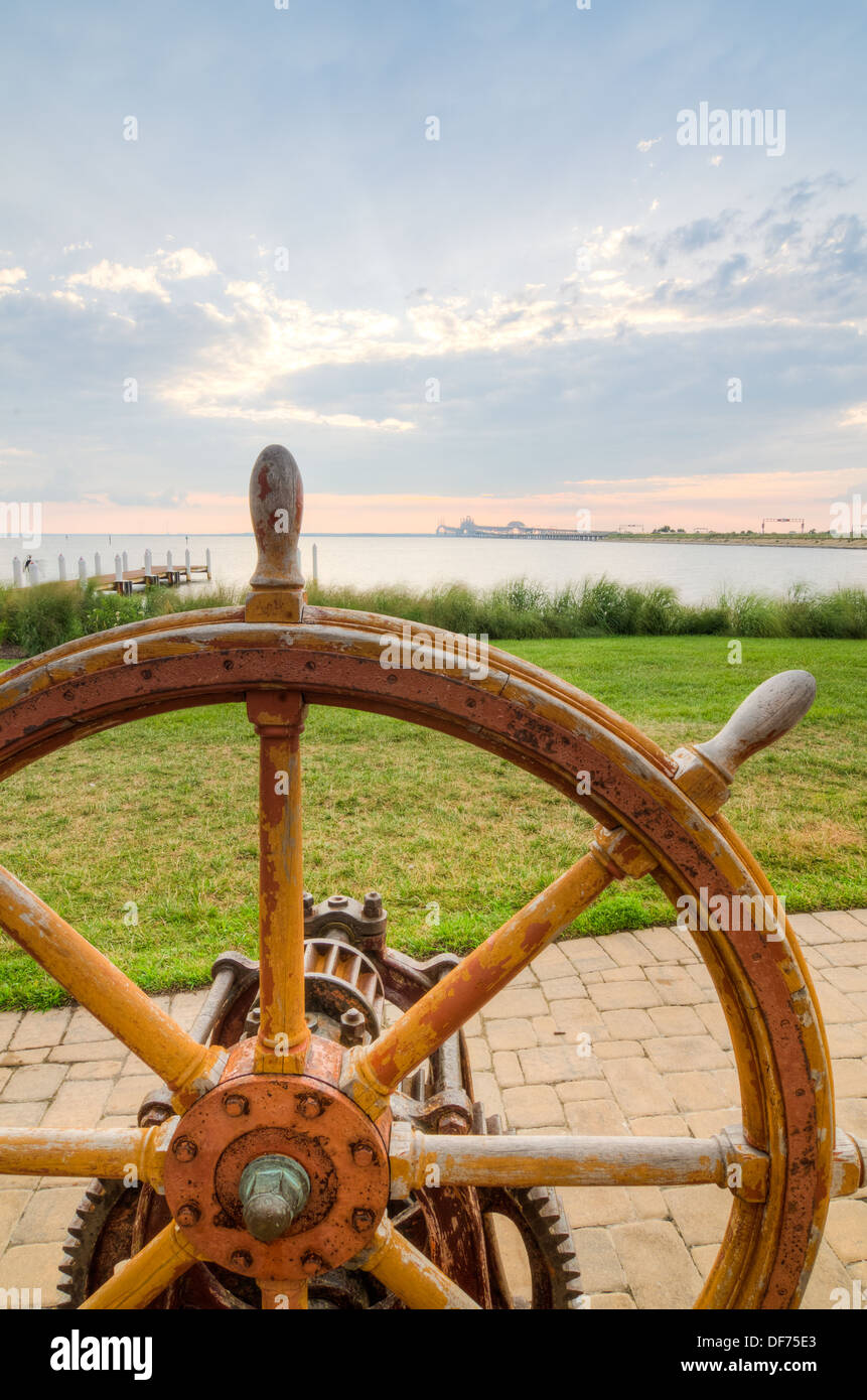 Ship's Wheel with the Chesapeake Bay Bridge in the Background Stock Photo