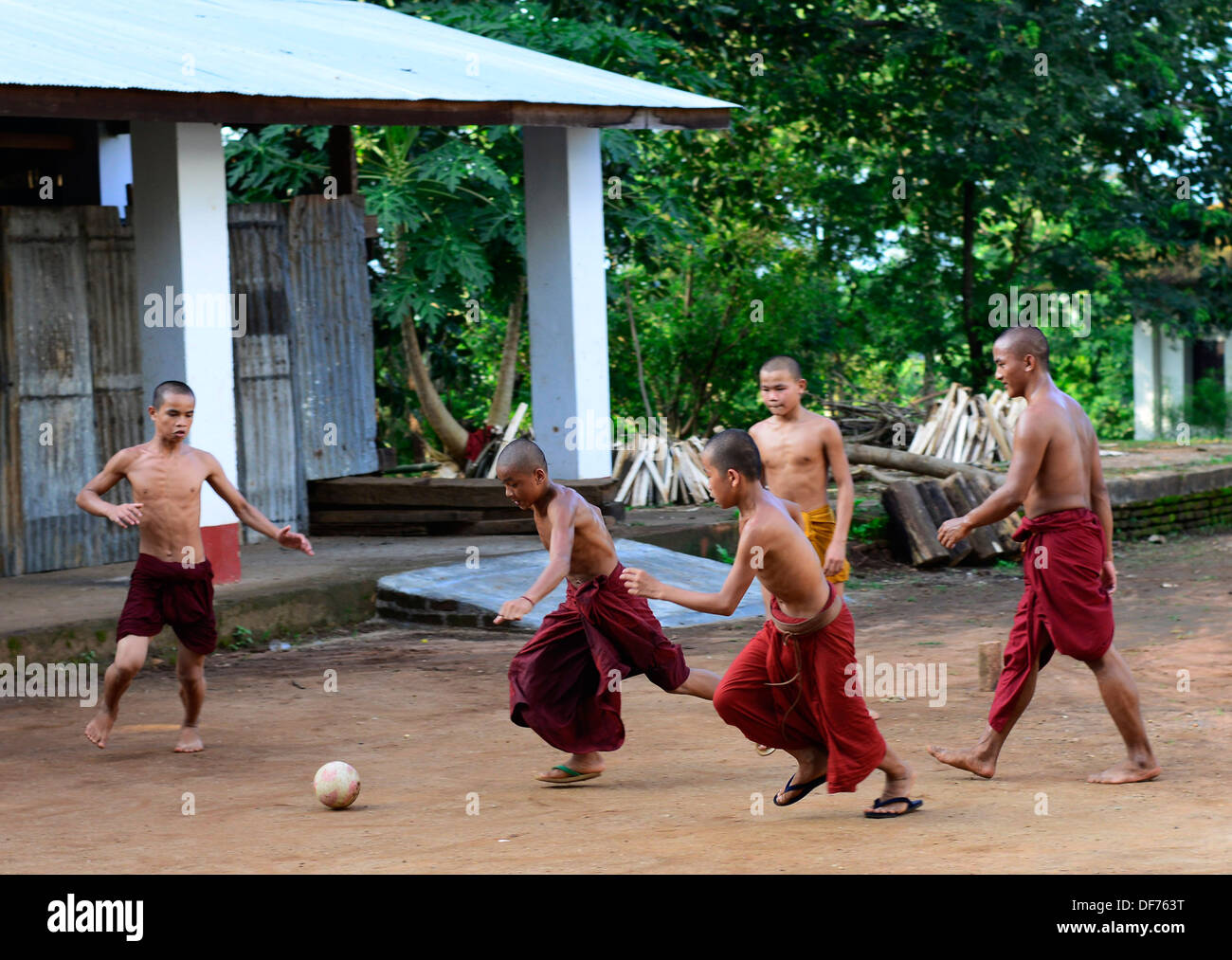 Burmese Buddhist monks playing soccer. Stock Photo