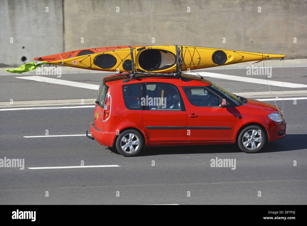 Car roof rack loaded with two kayak canoes driving along motorway Stock  Photo - Alamy