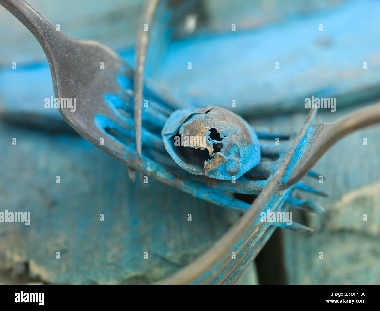 macro of a contemporary artwork made out of forks, metal and blue paint Stock Photo