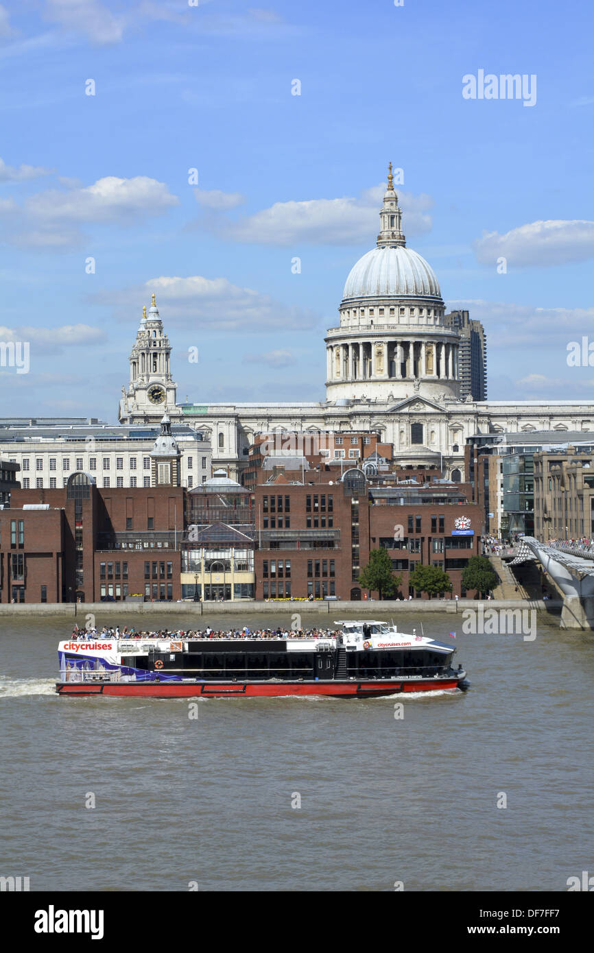 River Thames sightseeing tour boat passing the dome of St Pauls cathedral Stock Photo