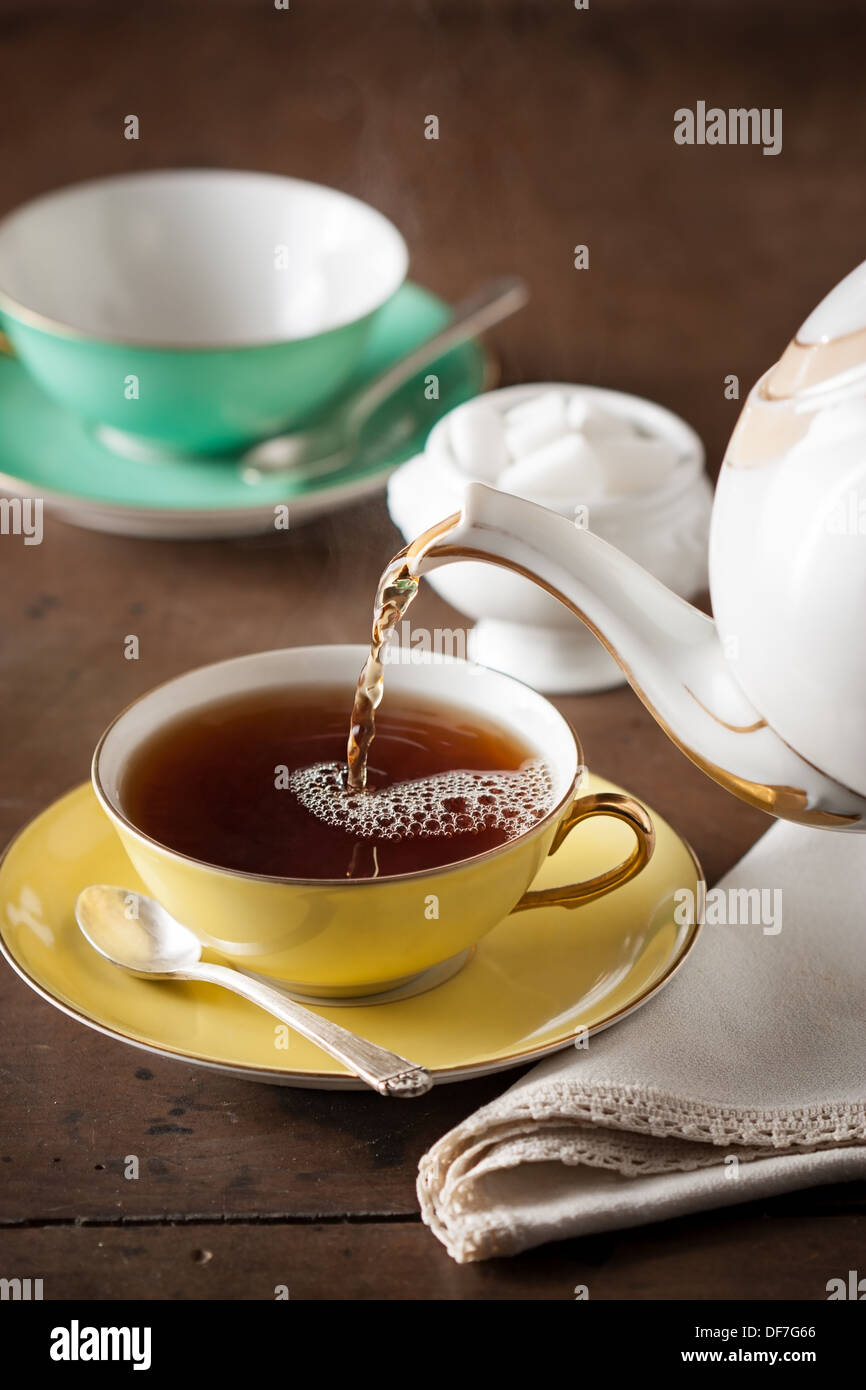 Serving tea with vintage teapot Stock Photo Alamy