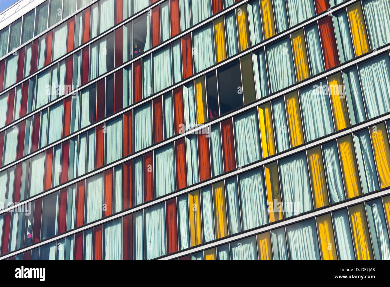 Tall, thin coloured glass window panes of the Crowne Plaza hotel, Manchester. Stock Photo