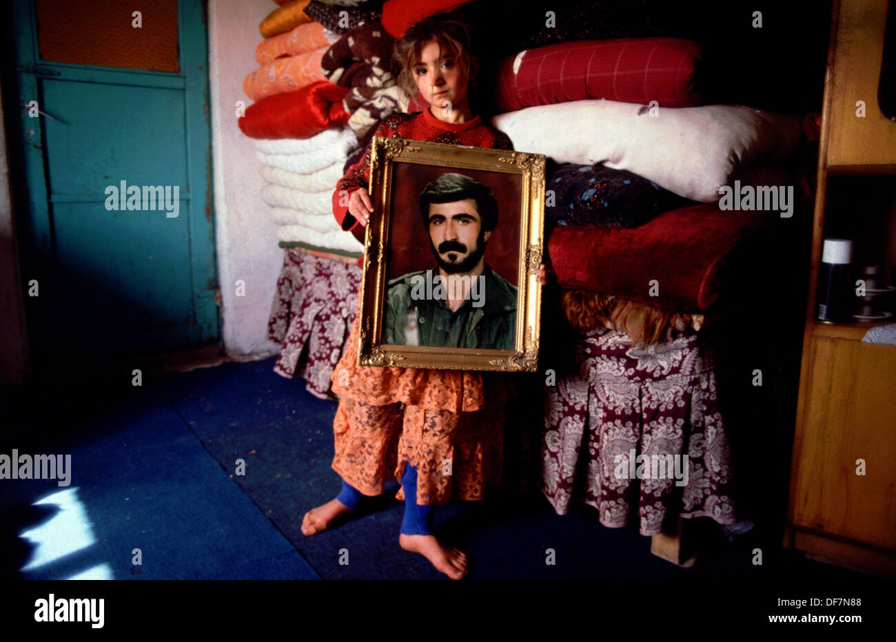 March 1993. Cizre south east Turkey Kurdistan. A Kurdish girl holds a portrait of her brother - a PKK fighter killed in combat with Turkish Forces the previous year. More than 45,000 people have died in the war between separatist Kurds and Turkish government forces since fighting began in 1984. Stock Photo