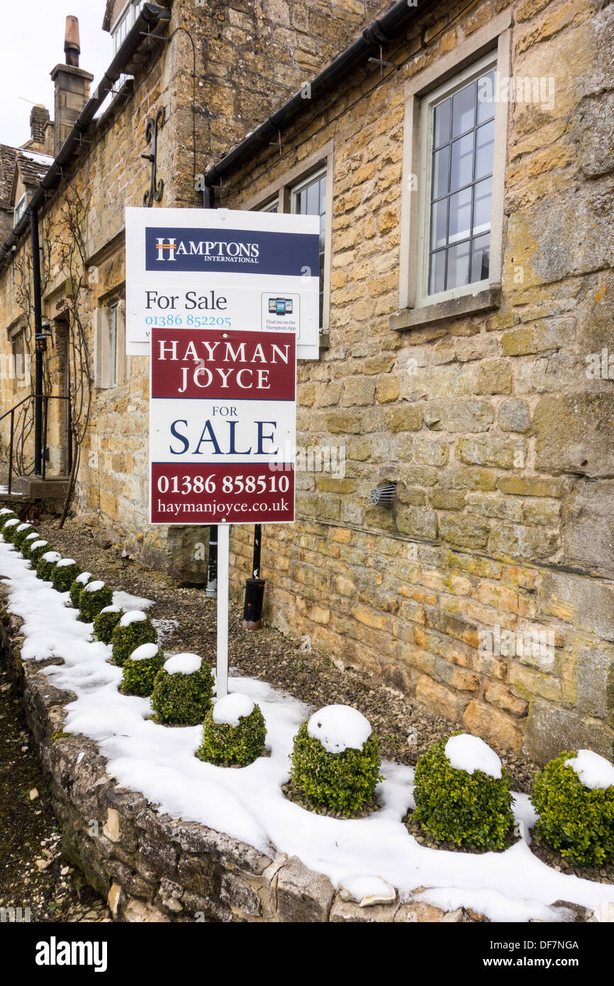 For sale signs by estate agents in Snowshill, Gloucestershire, UK Stock