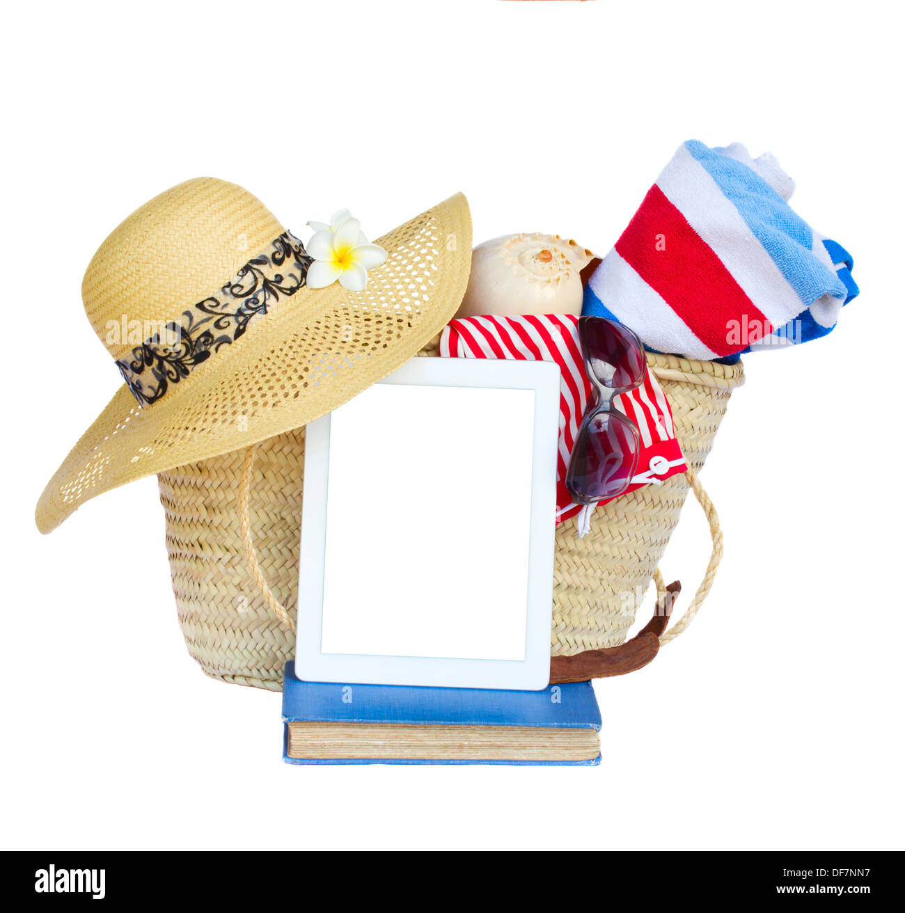 sunbathing accessories in basket with tablet Stock Photo