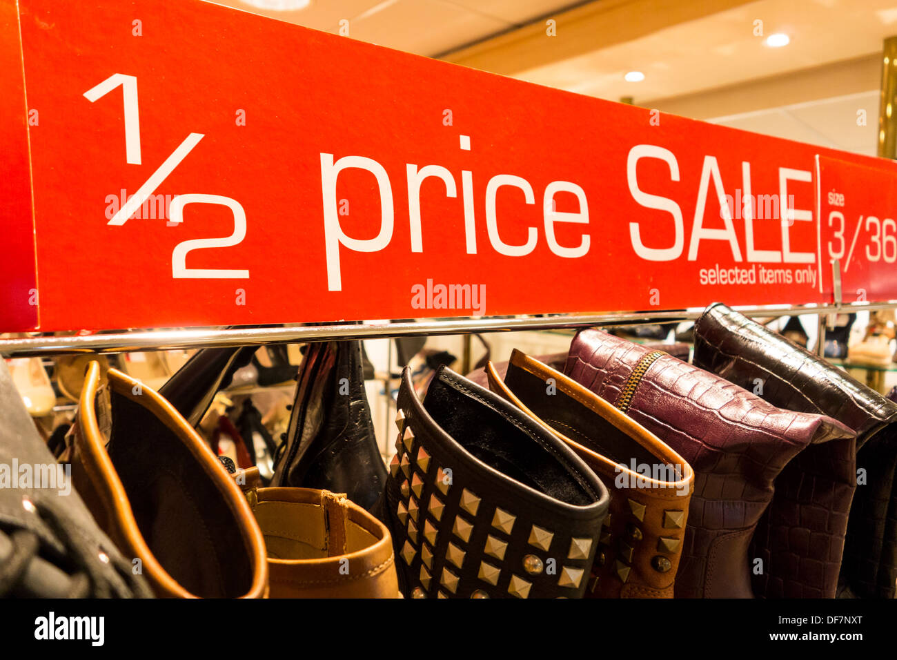 Red half price sign in shoe shop, UK Stock Photo