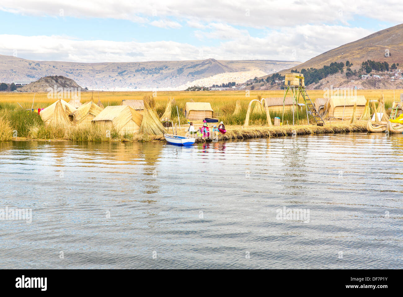 PUNO PERU - NOV 28: Unidentified women in traditional dresses welcome tourists in Uros Island Puno Peru NOV. 28. 2010.The Uros Stock Photo