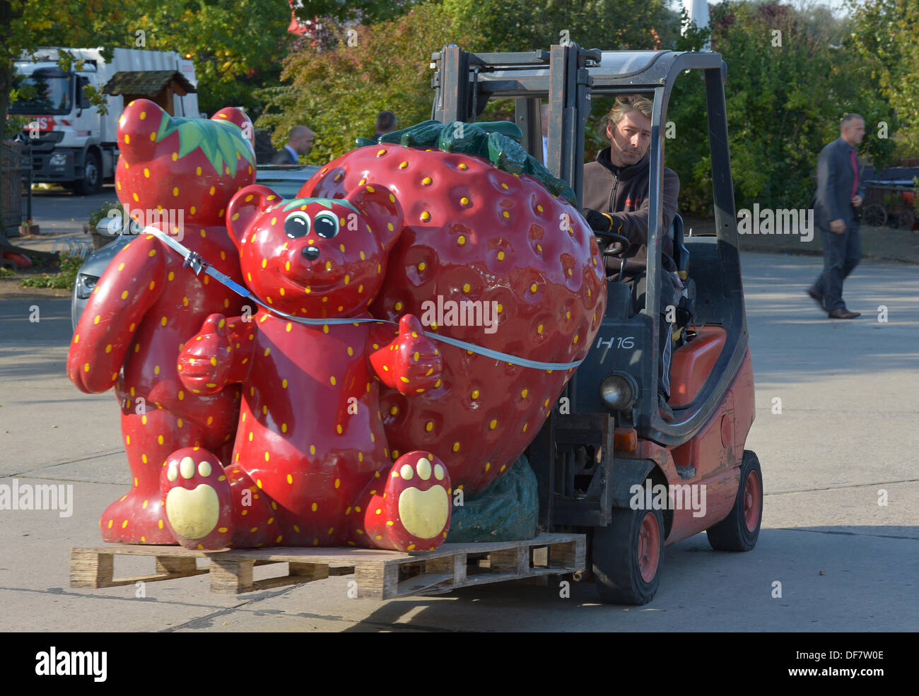 Giant figures of strawberries and bears that were used as decoration are brought away at an adventure farm in Beelitz, Germany, 30 September 2ß13. Photo: Ralf Hirschberger Stock Photo