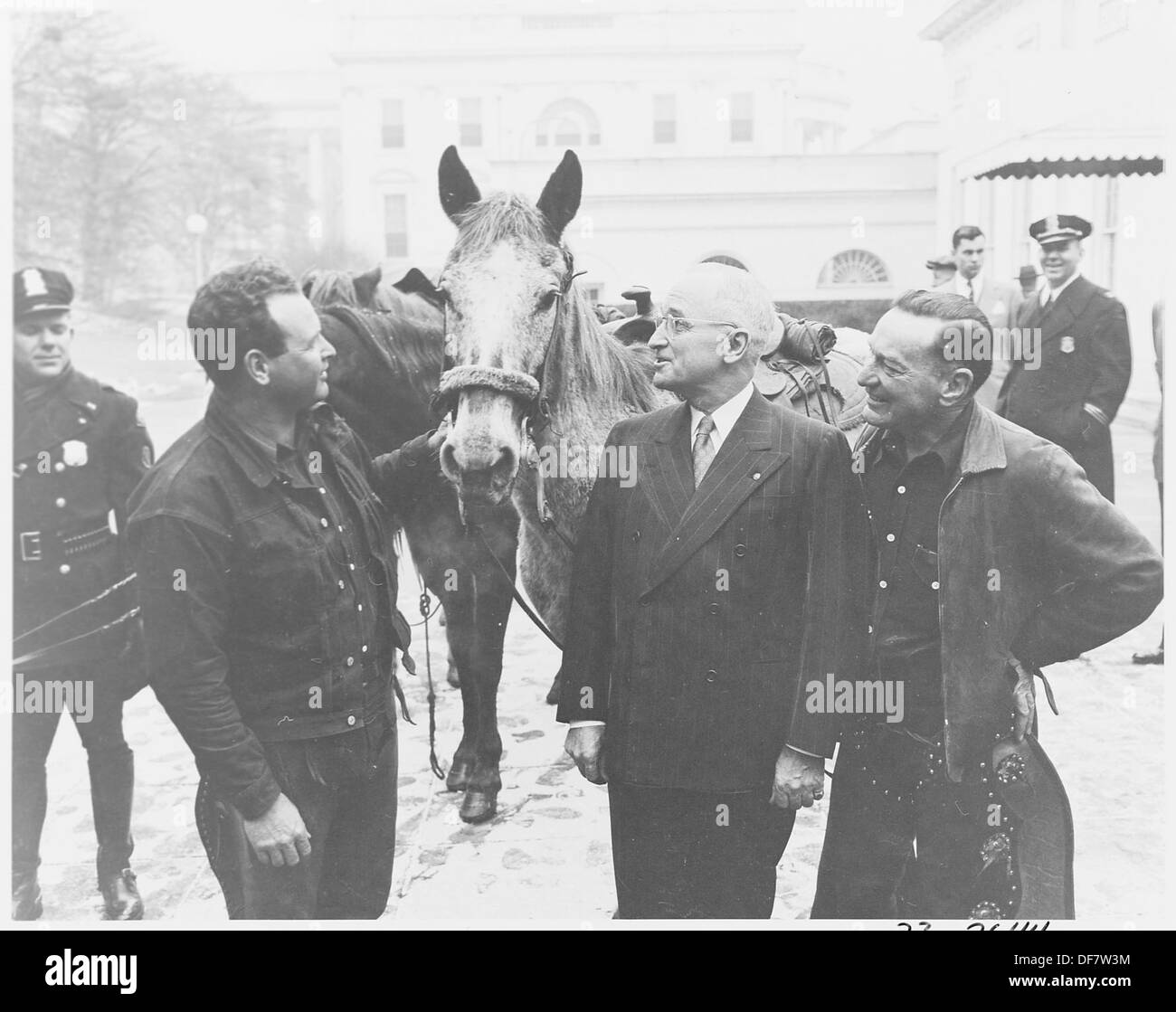 President Truman greets cross country horseback riders Ned Kennedy and