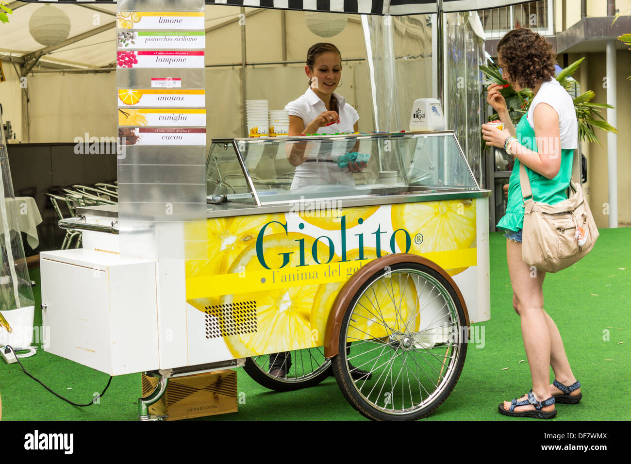 Young Woman Italian Ice Cream Seller and Young Woman Customer in Interaken, Switzerland Stock Photo