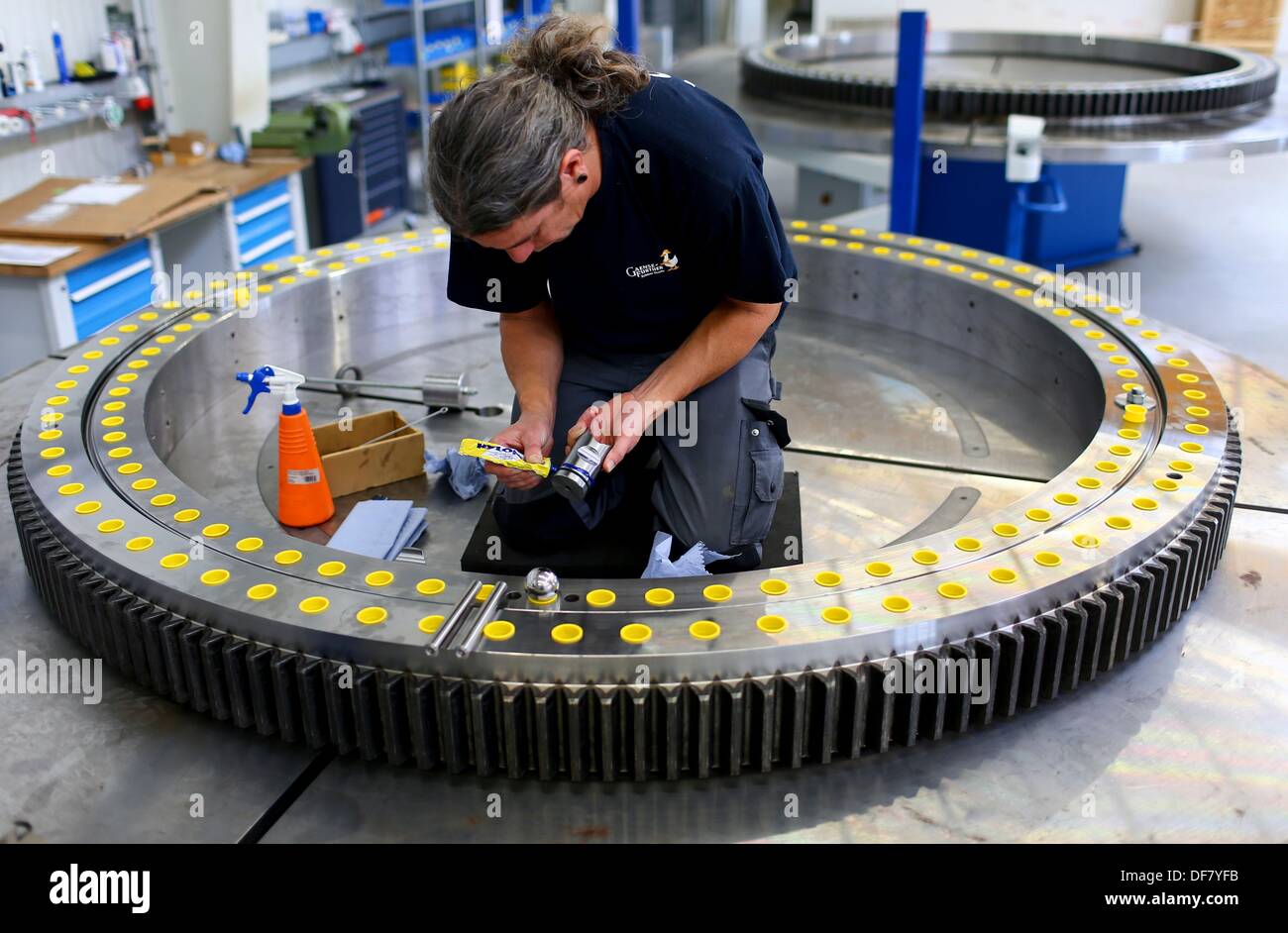 Steffen Haack works on a slewing bearing at company Hanse Drehverbindungen (HDV) in Wismar, Germany, 30 September 2013. The firm signed a cooperation agreement with the university in Wismar to create a testing plant for the large steel components. Photo: Jens Buettner Stock Photo