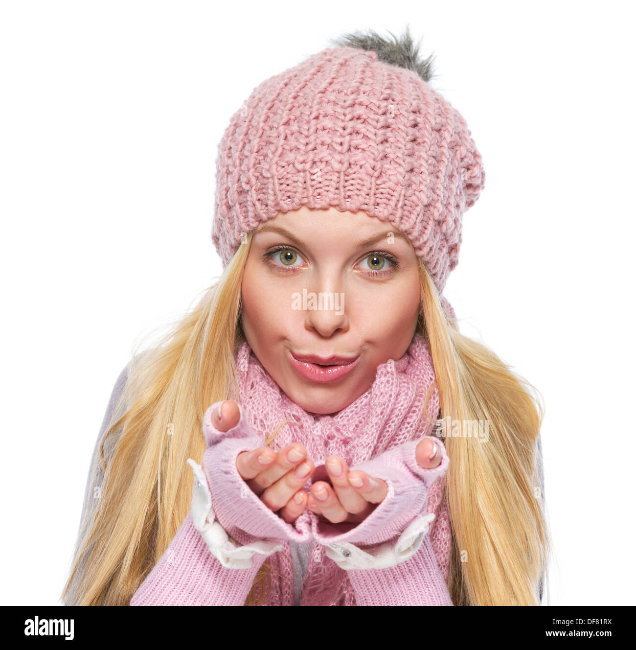 Girl in winter clothes blowing snow from hands Stock Photo Alamy