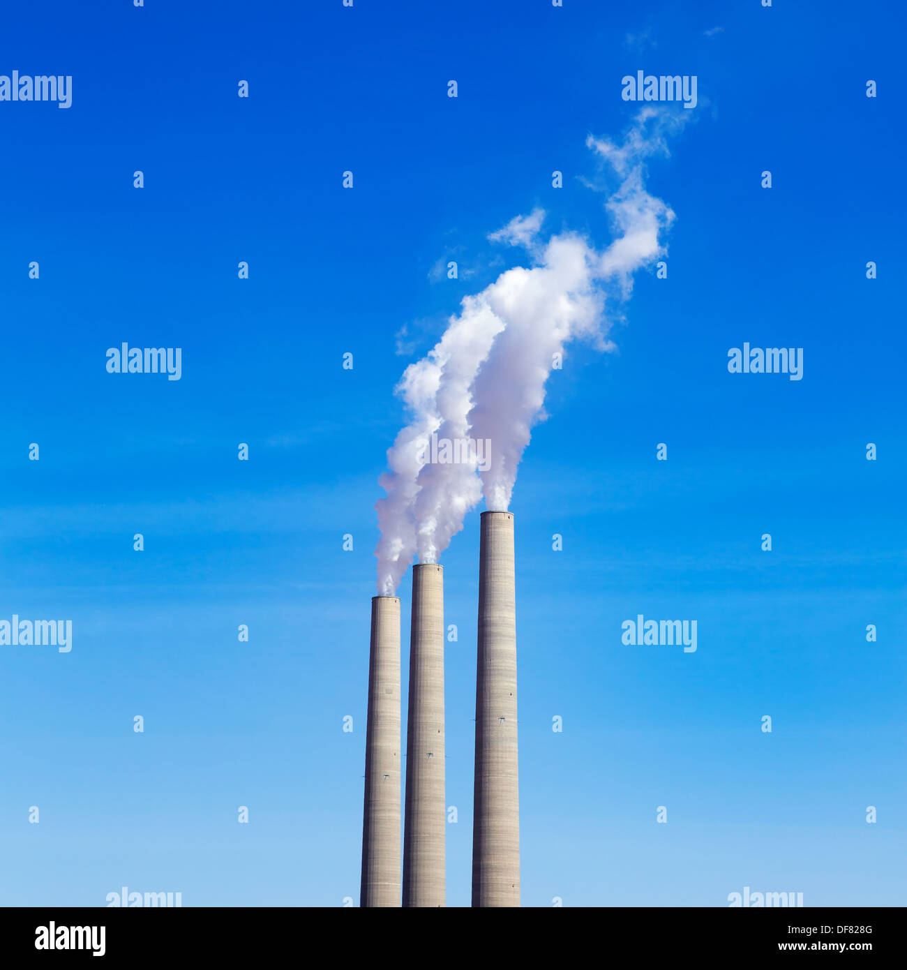 Chimney white smoke three in a row on a blue sky Stock Photo - Alamy