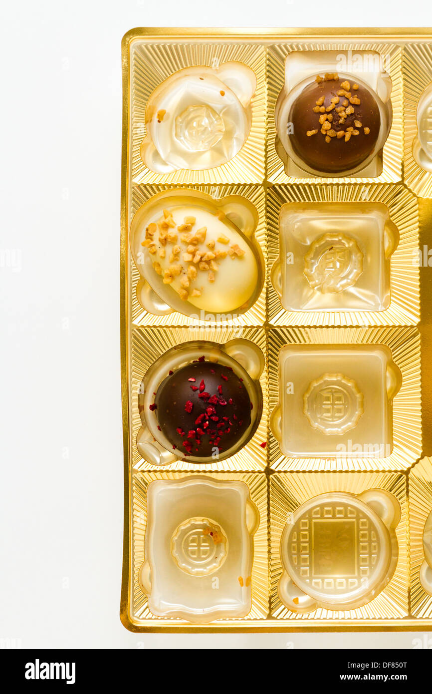 Gourmet chocolates in golden box on a white background Stock Photo Alamy