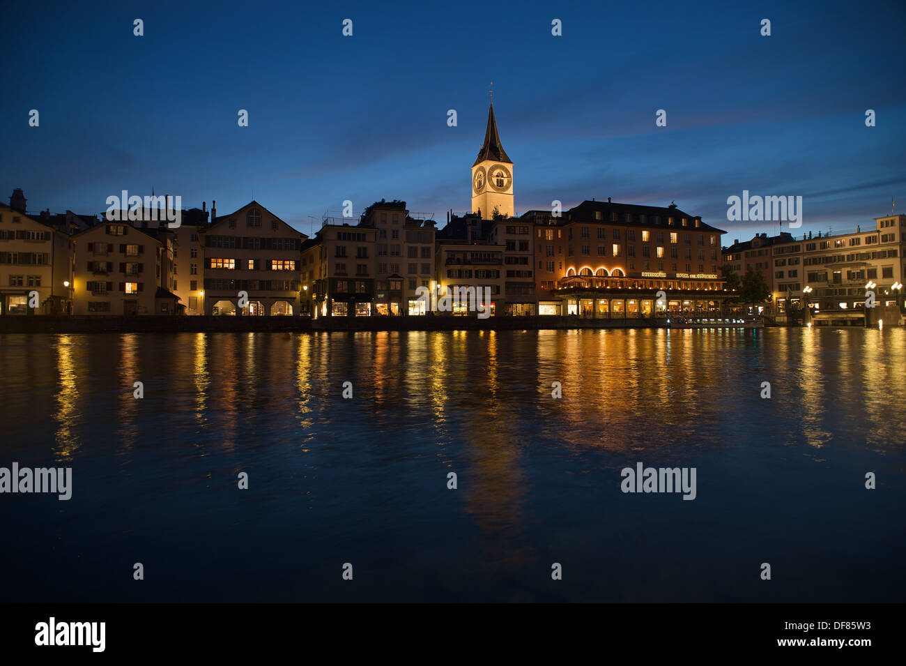 Reflection in the river Limmat of the buildings an churches of Zurich in the blue hour Stock Photo
