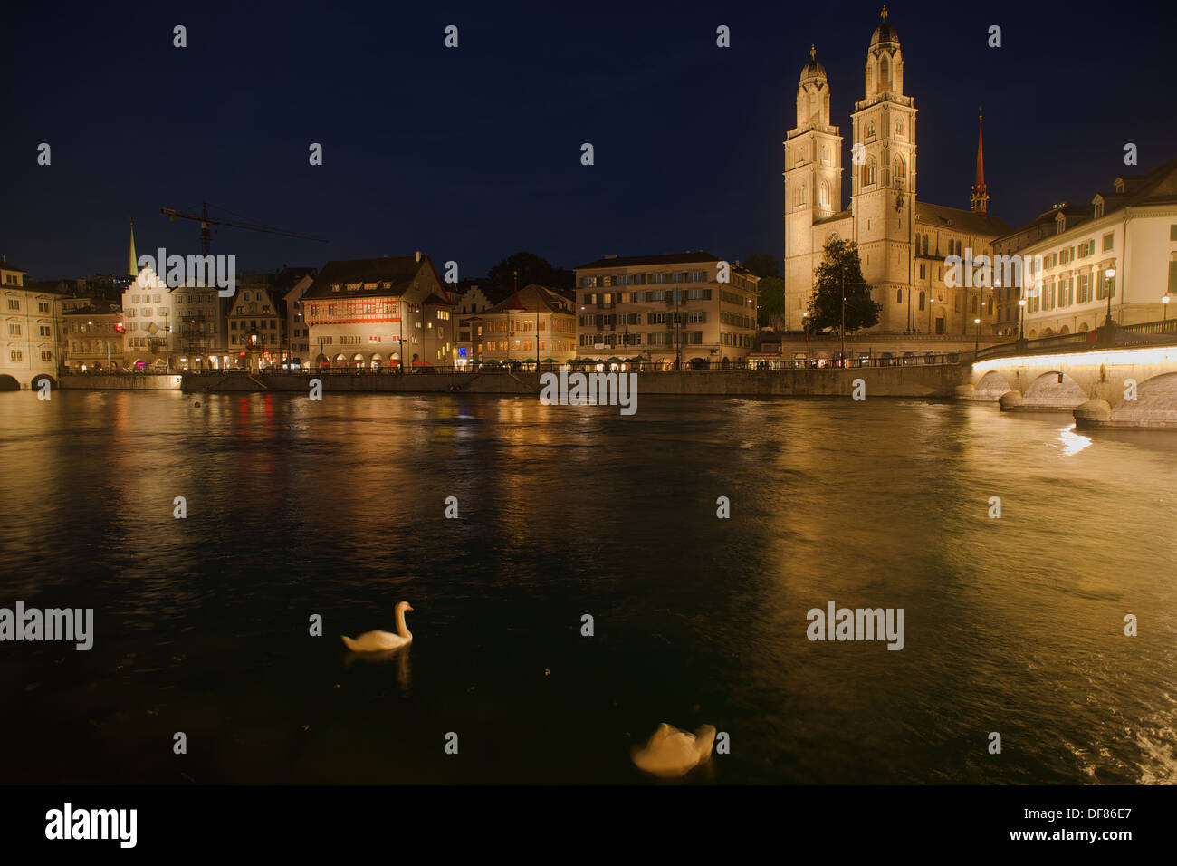 Reflection in the river Limmat of the buildings an churches of Zurich in the blue hour Stock Photo