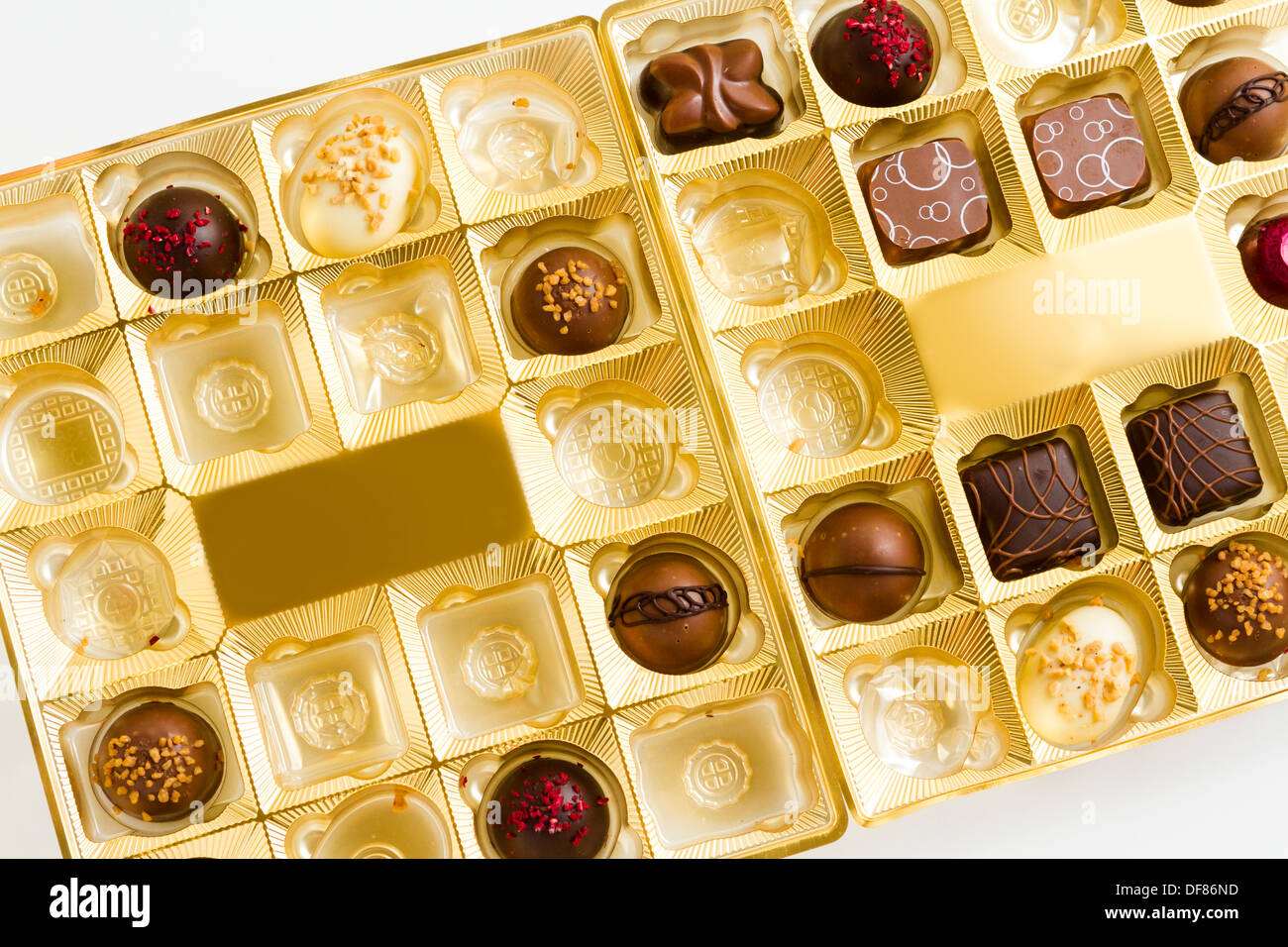 Gourmet chocolates in golden box on a white background Stock Photo Alamy