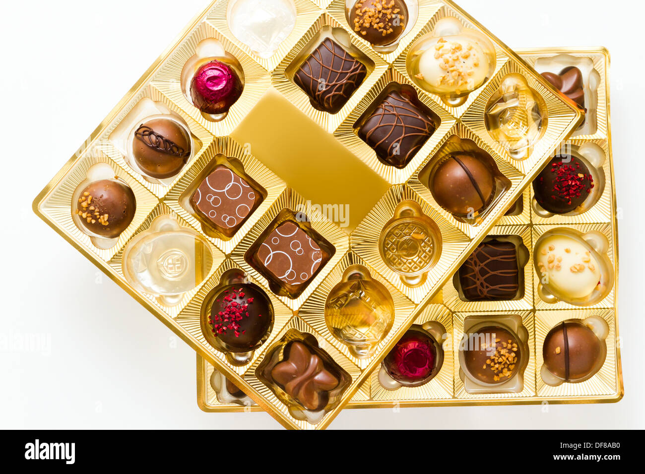Gourmet chocolates in golden box on a white background Stock Photo Alamy