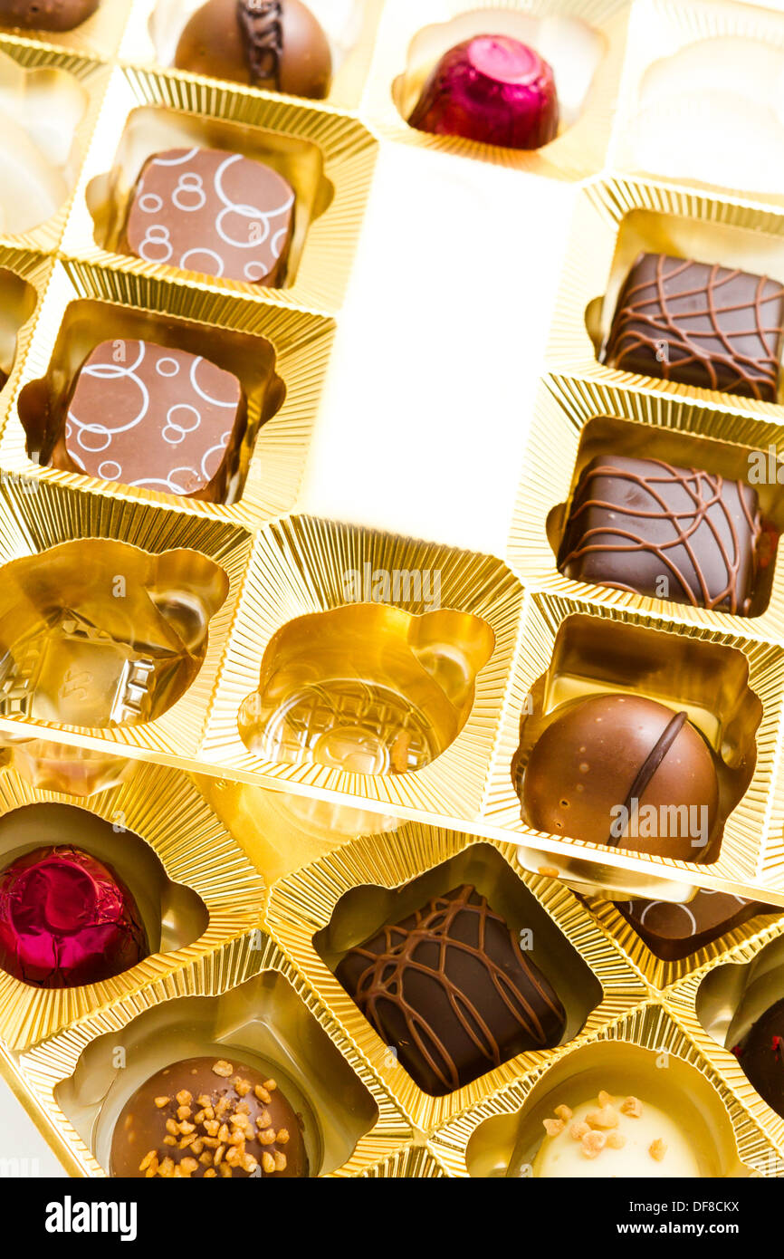 Gourmet chocolates in golden box on a white background Stock Photo Alamy