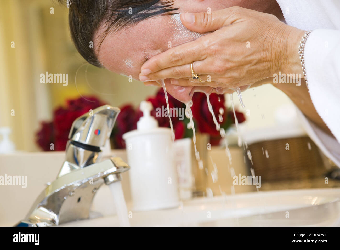 Woman washing face in the bathroom Stock Photo Alamy