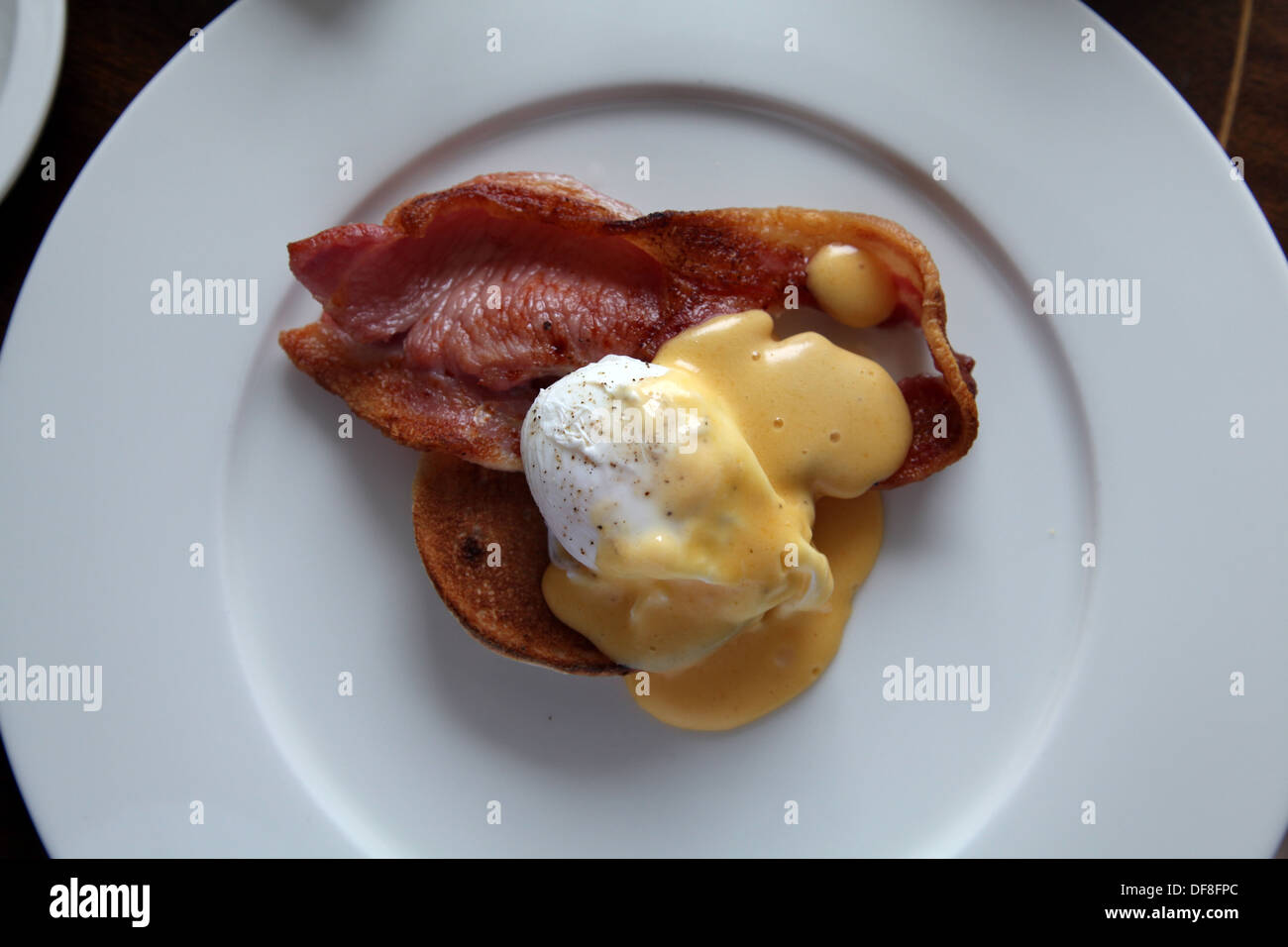eggs Benedict on a white plate Stock Photo