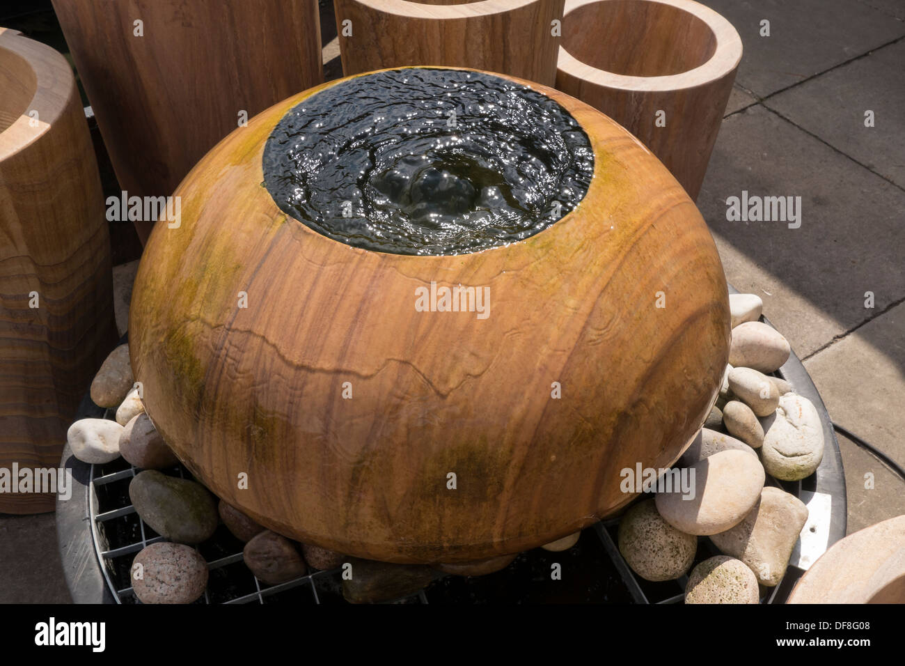 Round water feature fountain water welling up Stock Photo