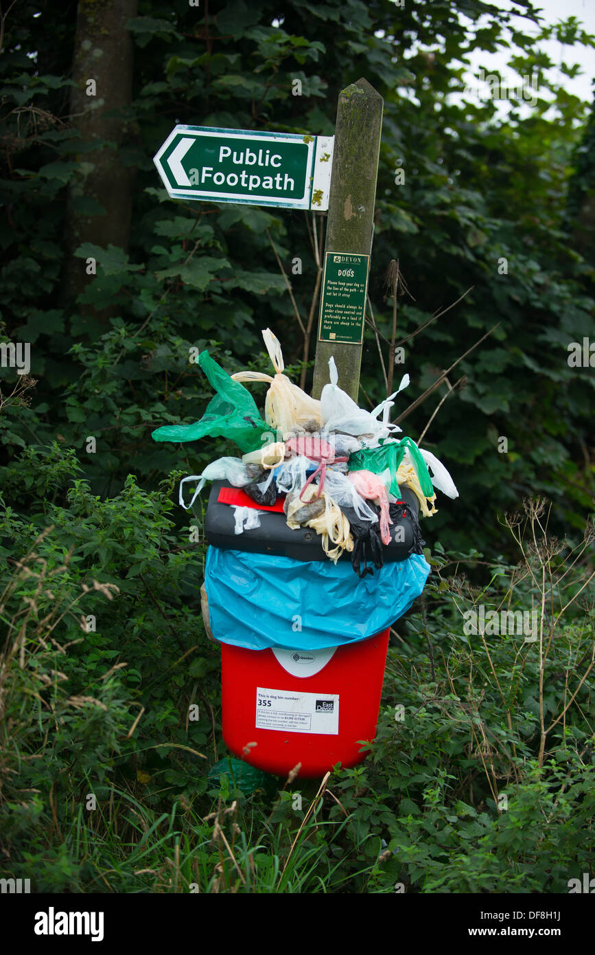 Dog waste bin overflowing with poo bags, eerily resembling a Damien