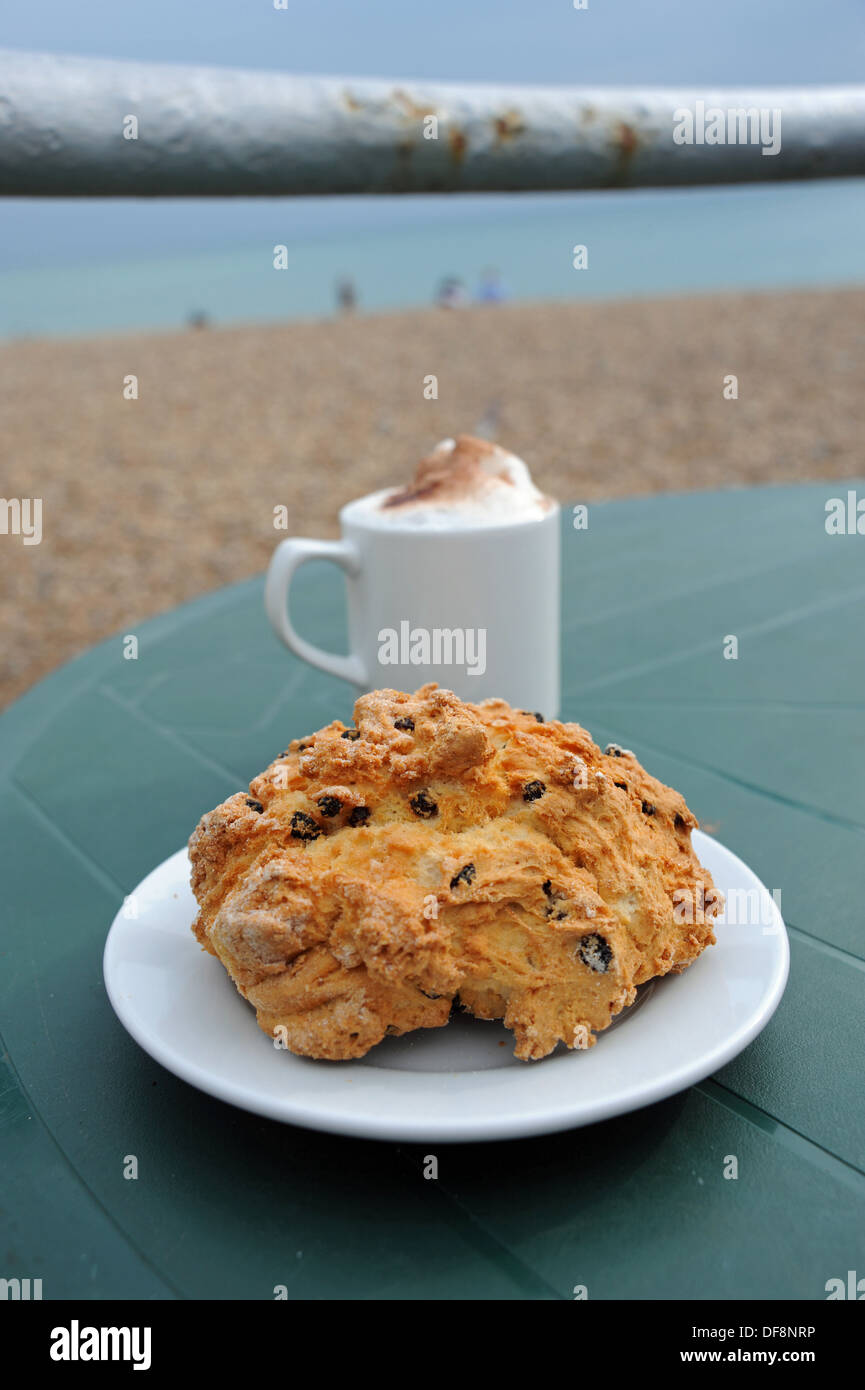 Rock cake and cappuccino coffee at an outdoor cafe table Stock Photo