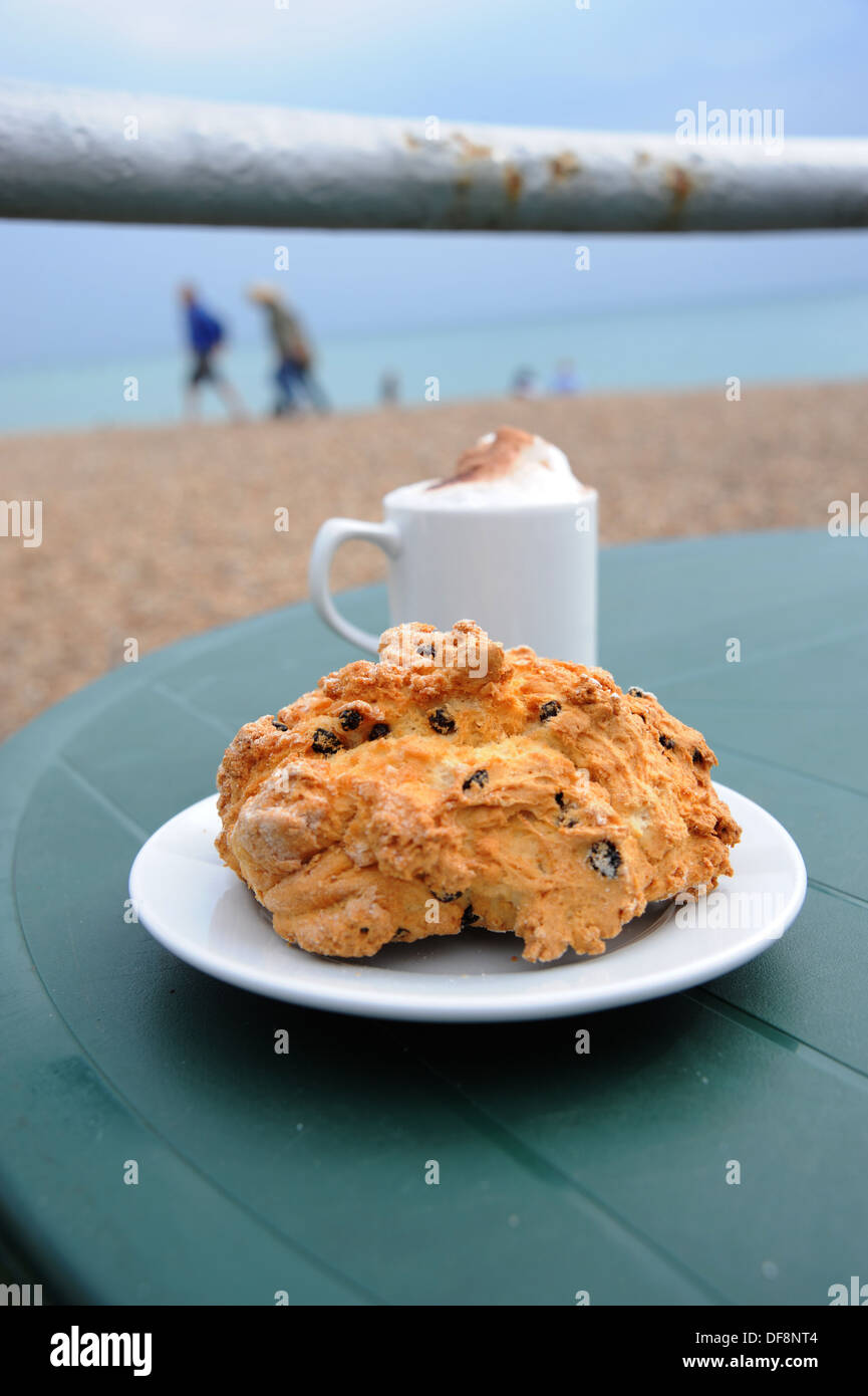 Rock cake and cappuccino coffee at an outdoor cafe table Stock Photo
