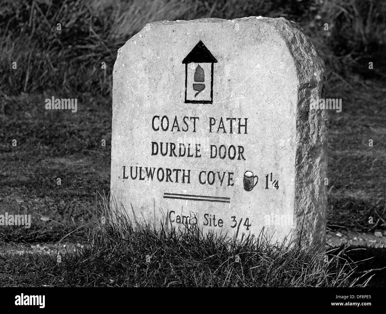 A Old Stone Path/Route Marker Marks The Coastal Walk From Durdle Door To Lulworth Cove, Dorset, England, Uk. (Black and white) Stock Photo