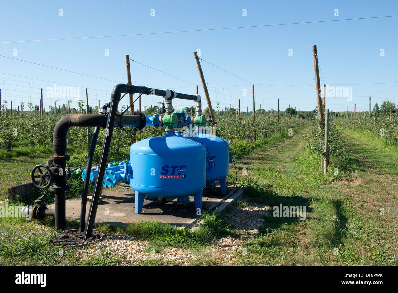 Irrigation and fertigation pump for cordon apple trees at Sainte-Foy-la-Grande, France Stock Photo