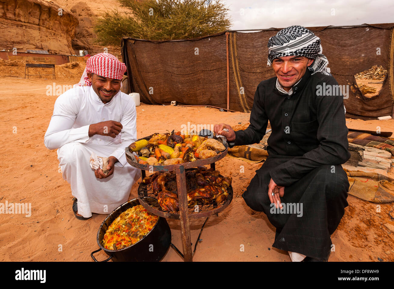 Bedouin men with a meal cooking in a pit in the ground, Captain´s Stock