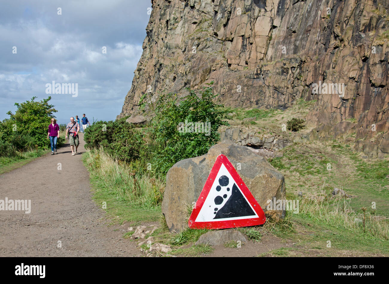 Walkers strolling along the Radical Road alongside Salisbury Crags in Edinburgh's Holyrood Park. Stock Photo