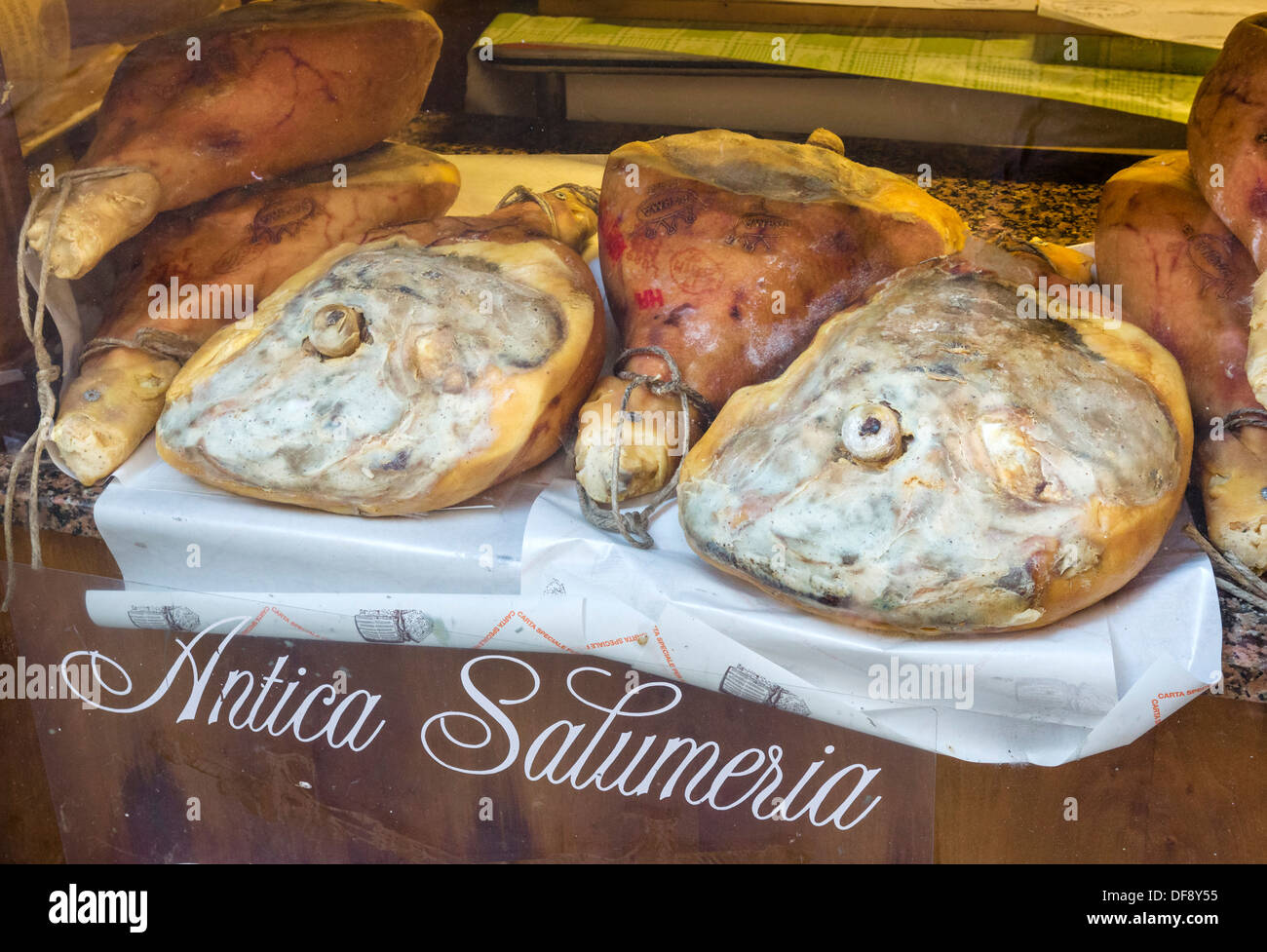 Whole parma hams in a traditional salumeria in the city centre, Reggio Emilia, Emilia Romagna, Italy Stock Photo
