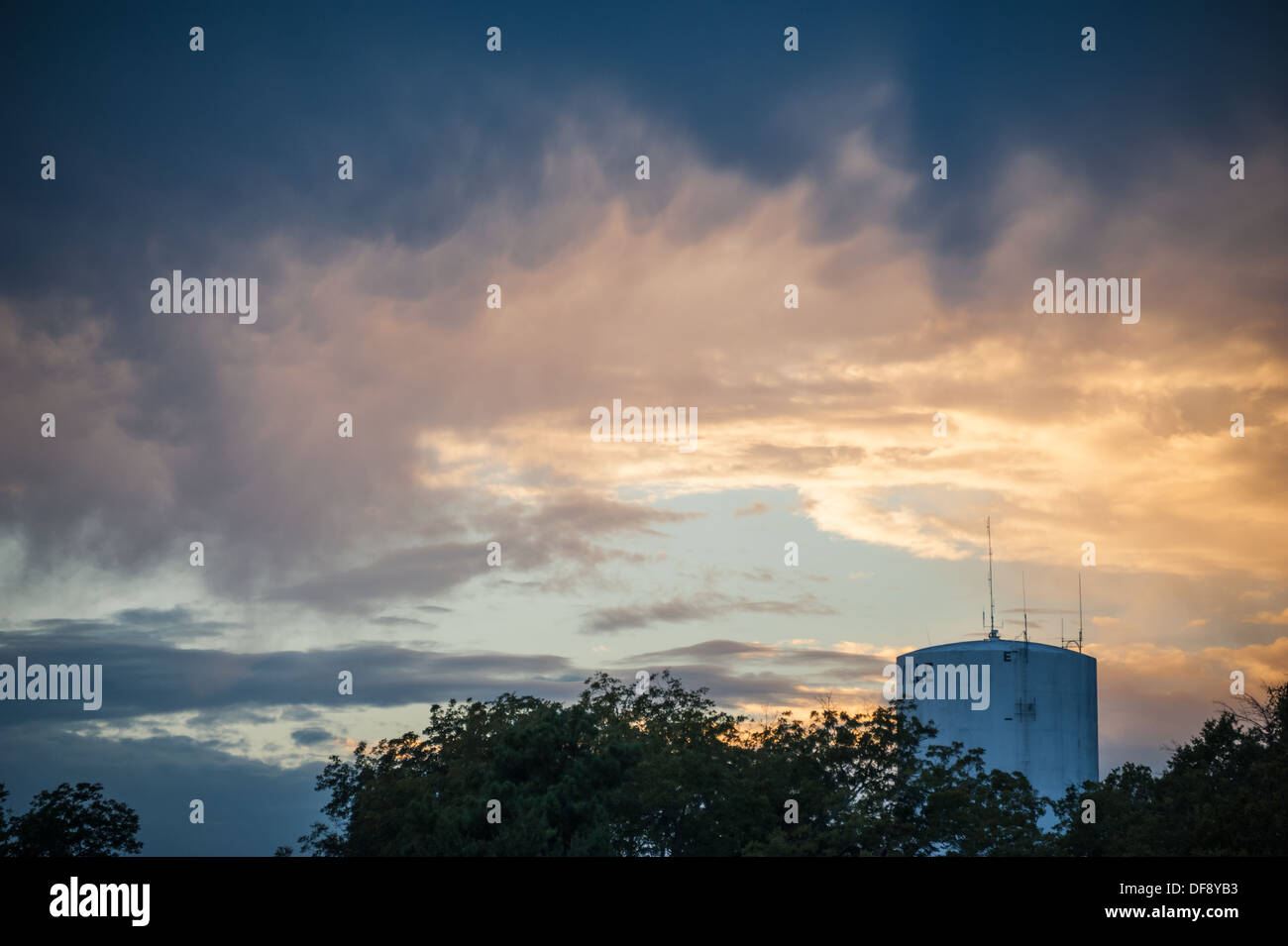 Dramatic sunset sky over a city water tower in Lawrenceville, Georgia. (USA). Stock Photo