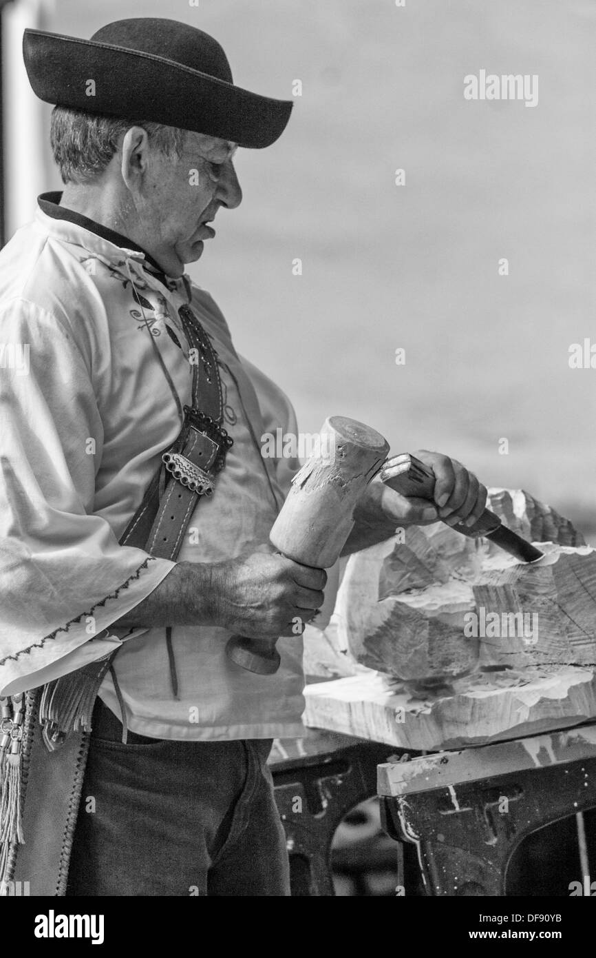 Wood carver during work with chisel and lime wood Stock Photo