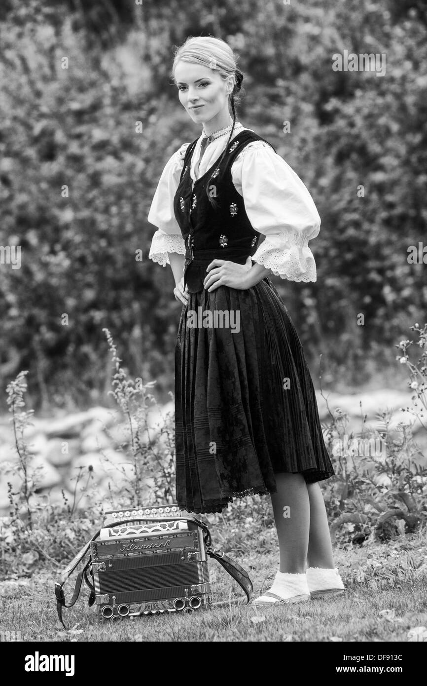 Woman in traditional folklore costume with accordion Stock Photo