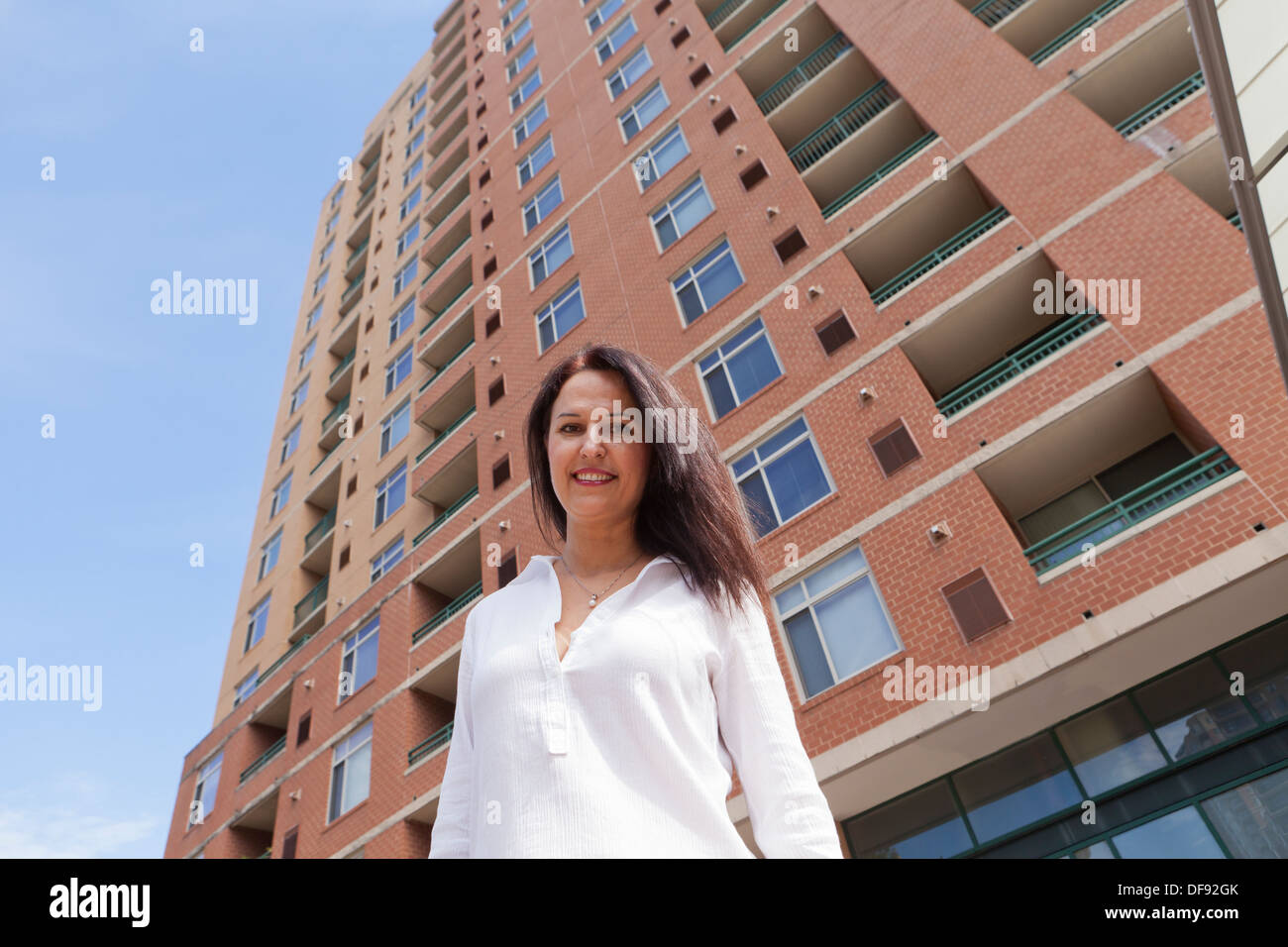 Middle aged Caucasian woman standing in front of building Stock Photo