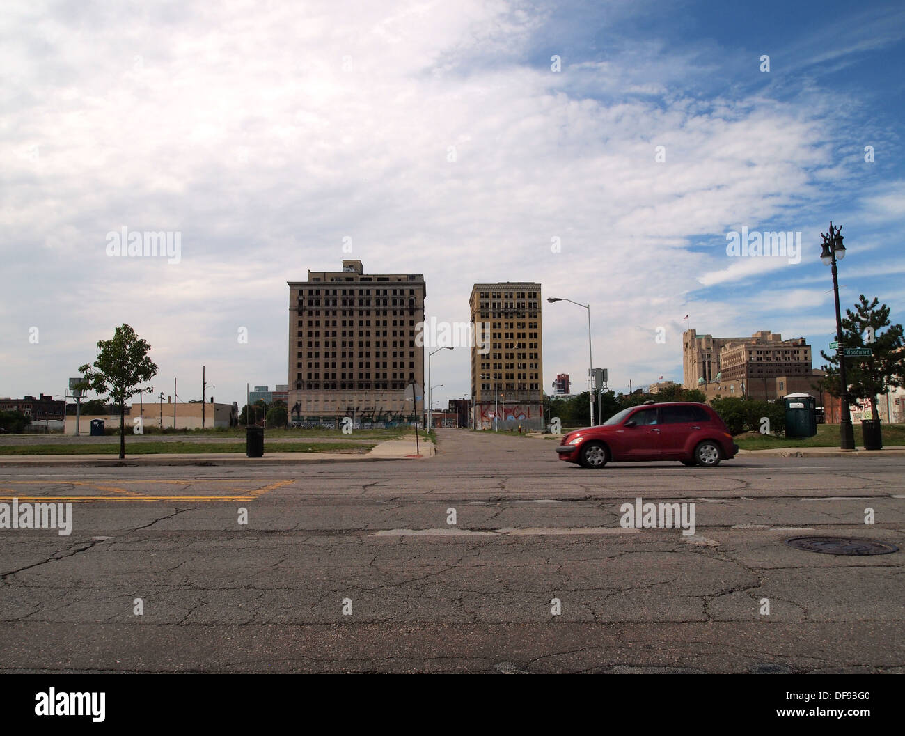 Car on Woodward Avenue passing abandoned and derelict tower blocks