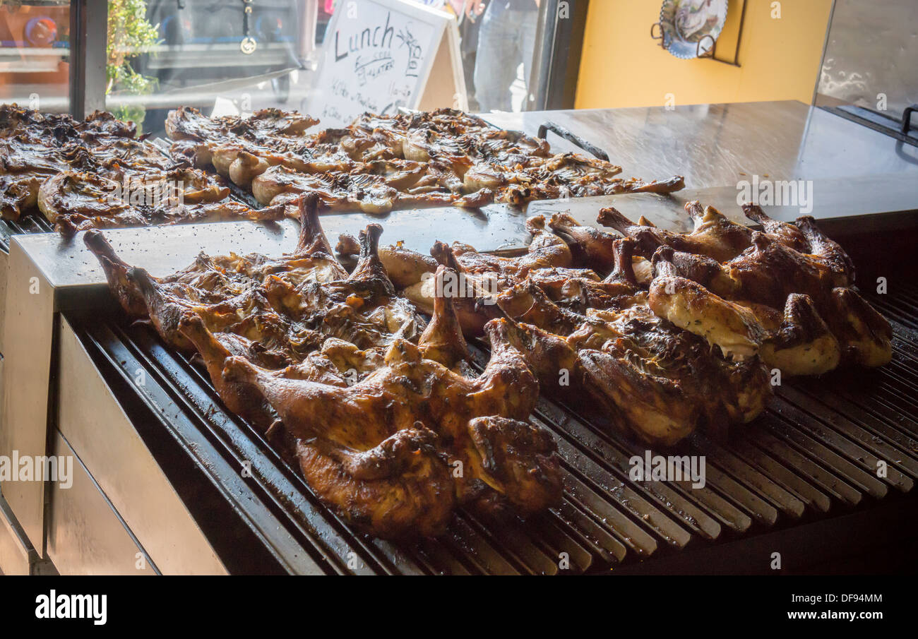 Chicken is grilled in a restaurant in the Jackson Heights neighborhood