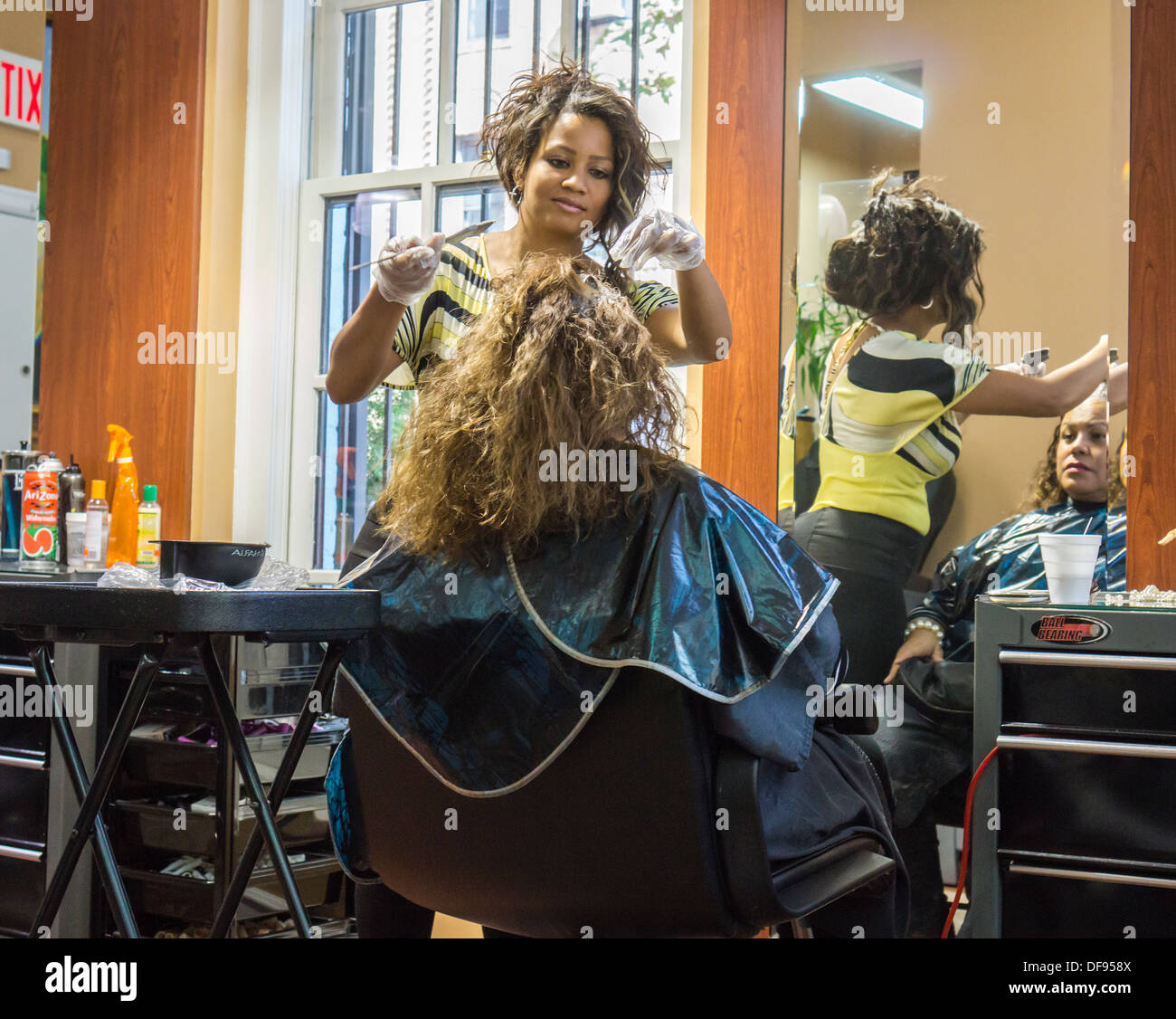 Customer has hair coloring in an Hispanic owned beauty salon in the Jackson Heights neighborhood of Queens in New York Stock Photo