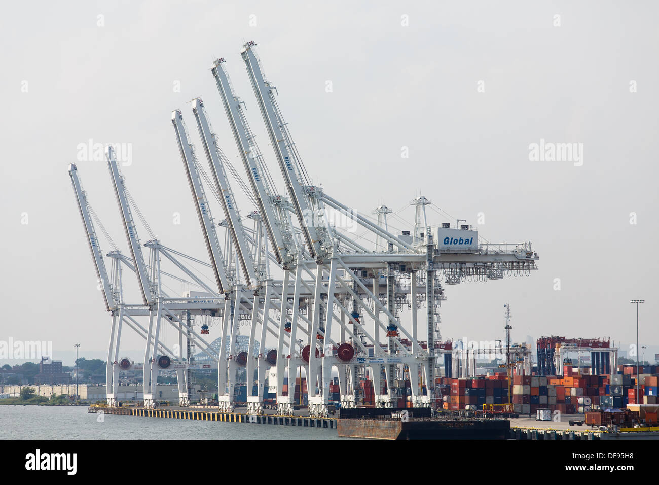 Shipping cranes and containers at a heavy, industrial shipping port Stock Photo