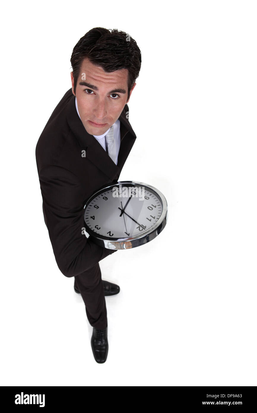 Businessman holding clock Stock Photo