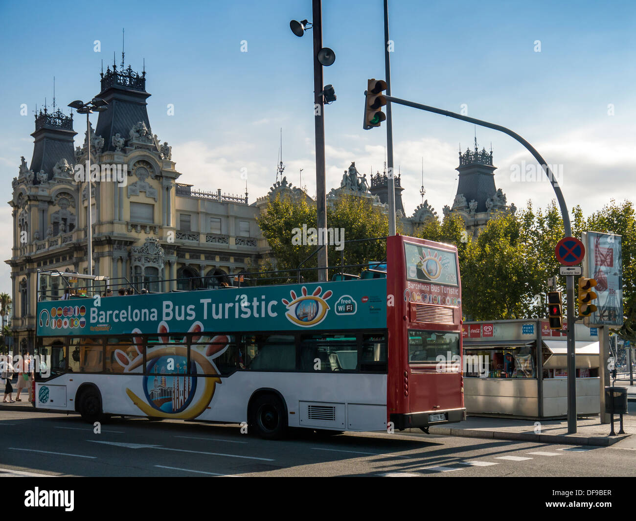 BARCELONA, SPAIN - SEPTEMBER 12, 2013: Tourist Bus in front of Old Port Authority Building in Port Vell area of Barcelona Stock Photo