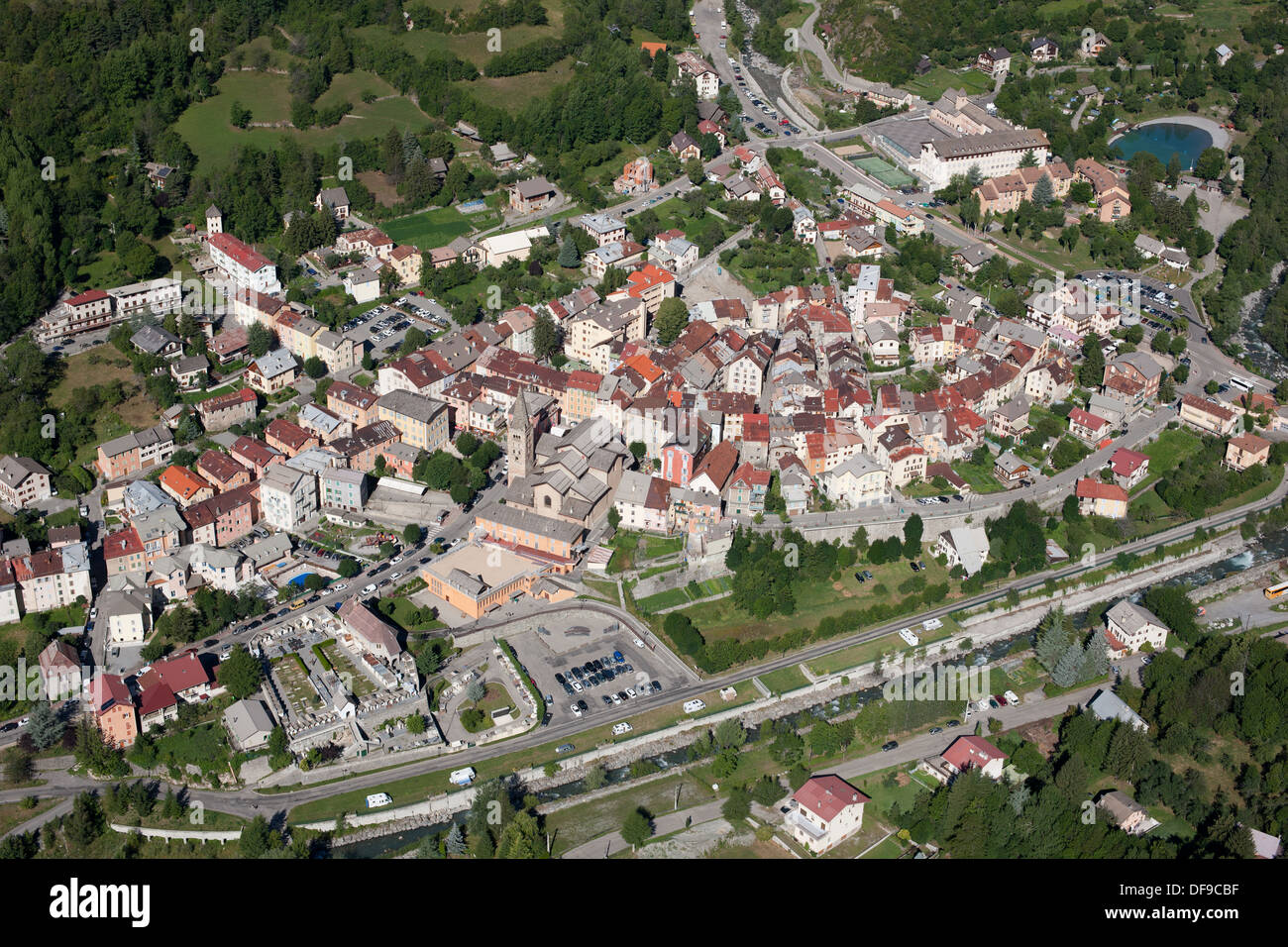AERIAL VIEW. Small town in the upper Tinée Valley. Saint-Étienne-de-Tinée, French Riviera's hinterland, France. Stock Photo
