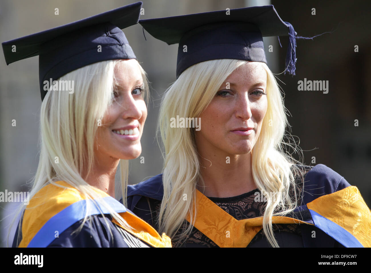 Identical twins Sam (left)and Becky Wycherley,23,celebrating today after graduating with First class honour degrees in nursing. Stock Photo