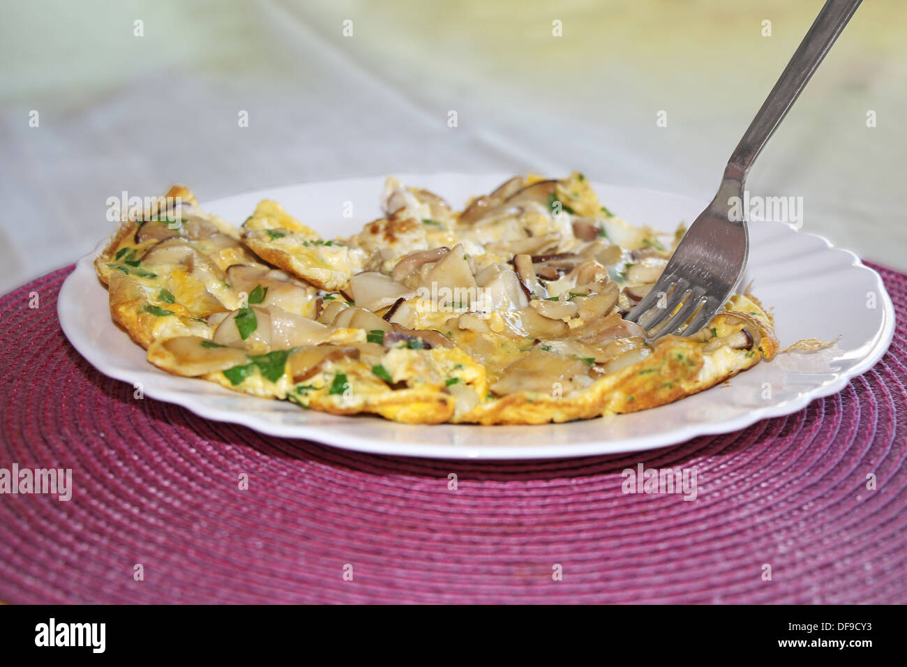 Scrambled eggs with mushrooms boletus on the plate Stock Photo