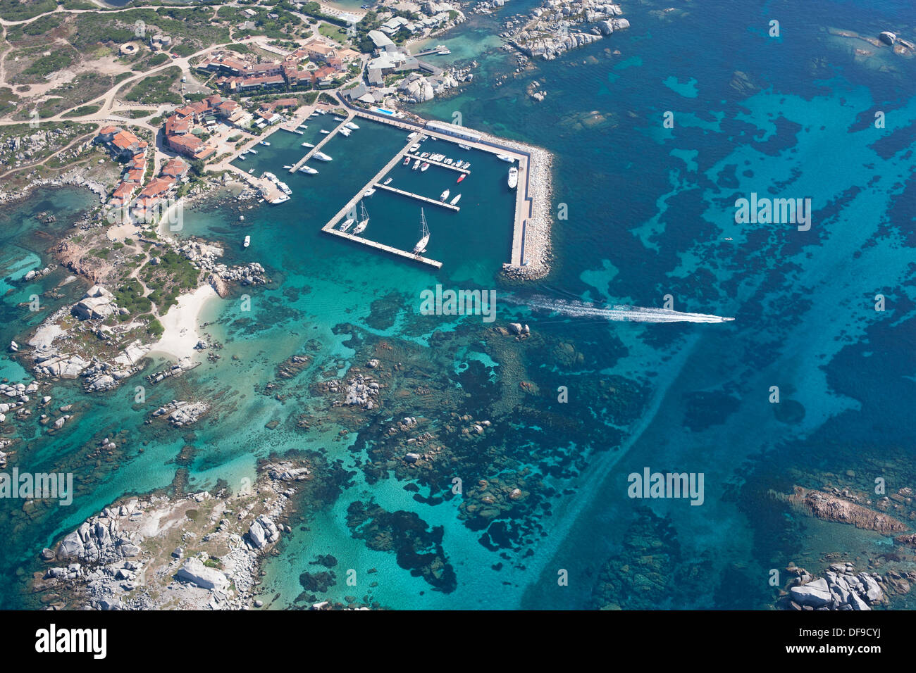 AERIAL VIEW. Small marina with a seabed displaying a stunning blue. Cavallo Island, Lavezzi Archipelago, Bonifacio, Corsica, France. Stock Photo